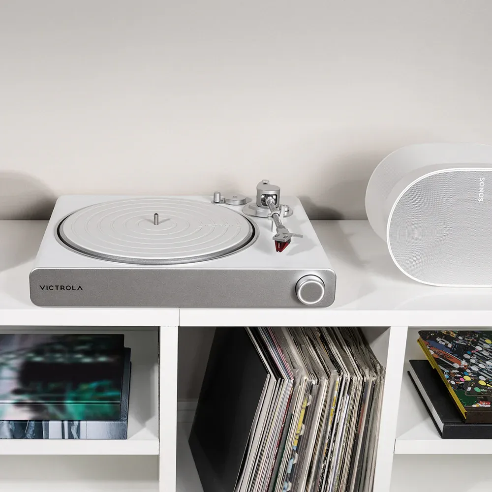 Victrola turntable with vinyl records and speaker