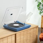 victrola automatic turntable + victrola tempo bookshelf speakers bundle blue Blue turntable playing vinyl on wooden cabinet