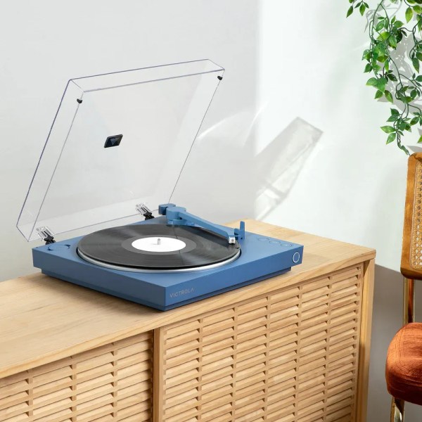 victrola automatic turntable + victrola tempo bookshelf speakers bundle blue Blue turntable playing vinyl on wooden cabinet