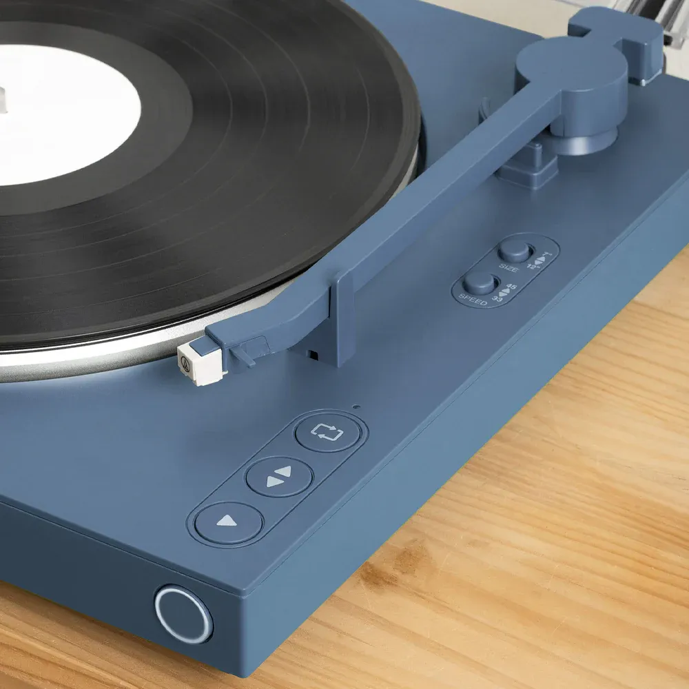 Modern blue turntable playing vinyl record