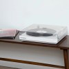 victrola automatic turntable white White turntable with vinyl record on wooden table