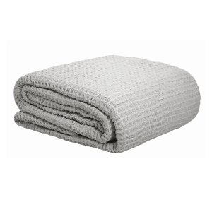 Folded light grey waffle-textured blanket