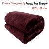 Folded burgundy faux fur throw blanket
