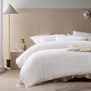 Modern bedroom with white textured quilt bedding