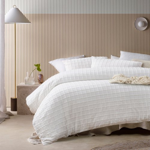 Modern bedroom with white textured quilt bedding
