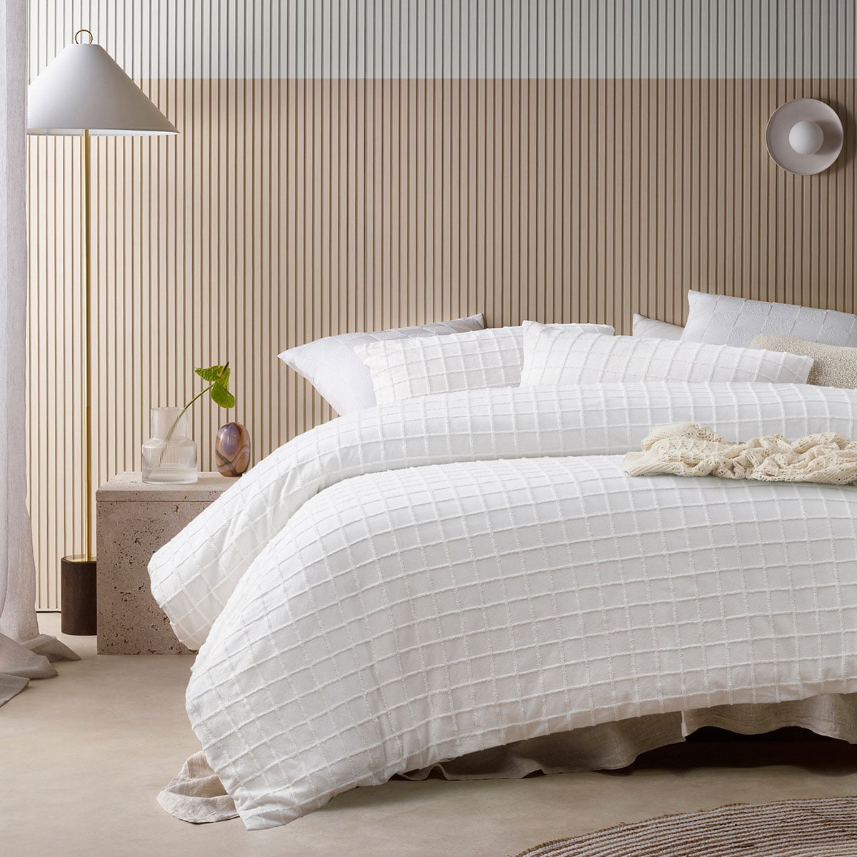 Modern bedroom with white textured quilt bedding