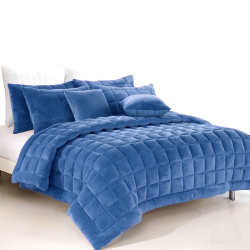 Blue quilted bedspread with matching pillows on bed