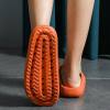 Orange clog sole with textured grip pattern