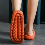 Close-up of orange clog sole on tiled floor
