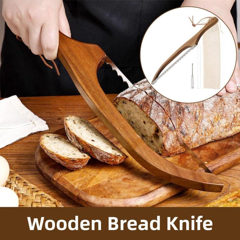 Wooden bread knife slicing crusty loaf