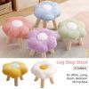 Pastel flower-shaped stools with wooden legs