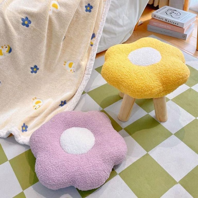 Flower-shaped stools and cushion in cosy room