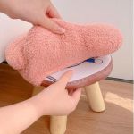 Pink fluffy stool cover on wooden stool
