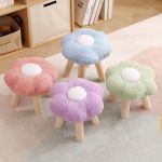 Pastel flower-shaped stools with wooden legs indoors