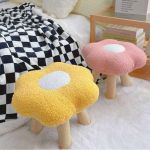 Flower-shaped stools in cosy bedroom setting