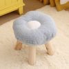 Soft flower-shaped stool with wooden legs