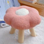Pink flower-shaped stool with wooden legs