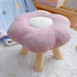 Pink flower-shaped plush stool with wooden legs