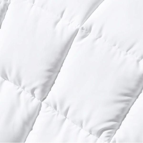 Close-up of white quilted fabric texture