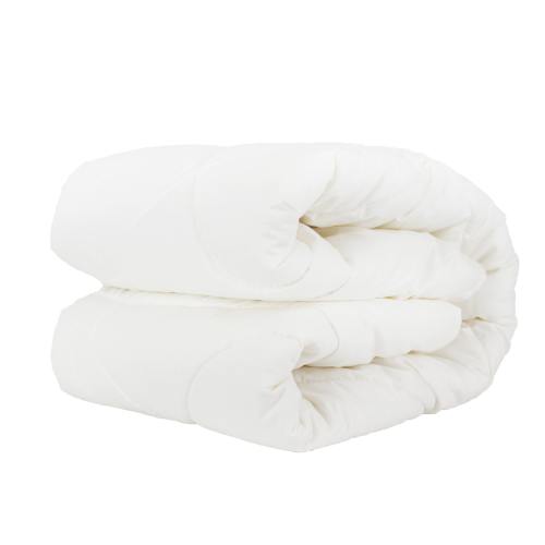 Folded white quilt on white background