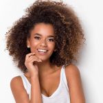 shea moisture purple rice water strength + color care conditioner 370ml 1260 gram Smiling woman with curly hair in studio portrait