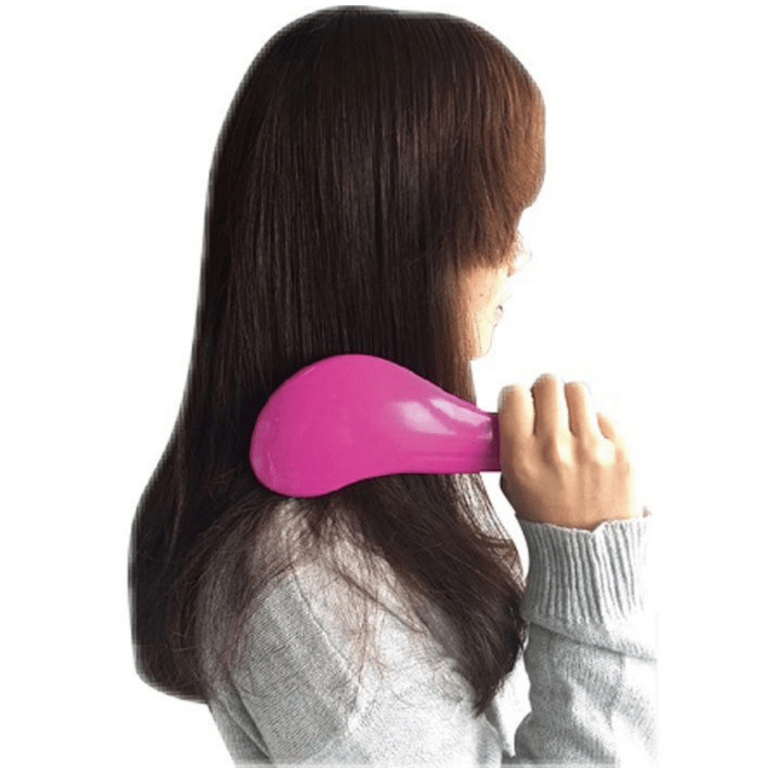 Woman brushing long brown hair with pink brush