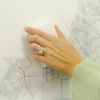 Hand wiping crayon drawings off wall