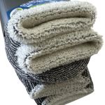 Folded wool blend throw blanket with label