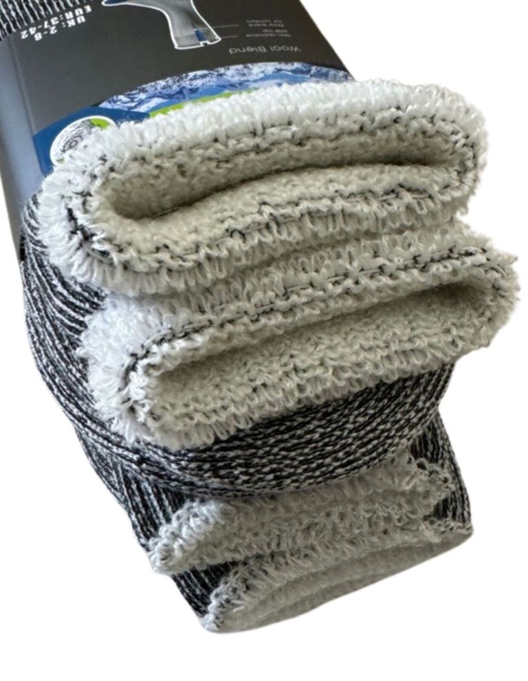 Folded wool blend throw blanket with label