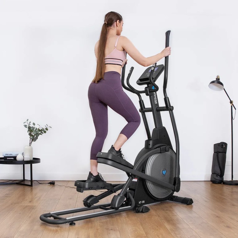 lifespan fitness xt 39 folding cross trainer Woman using elliptical trainer at home gym