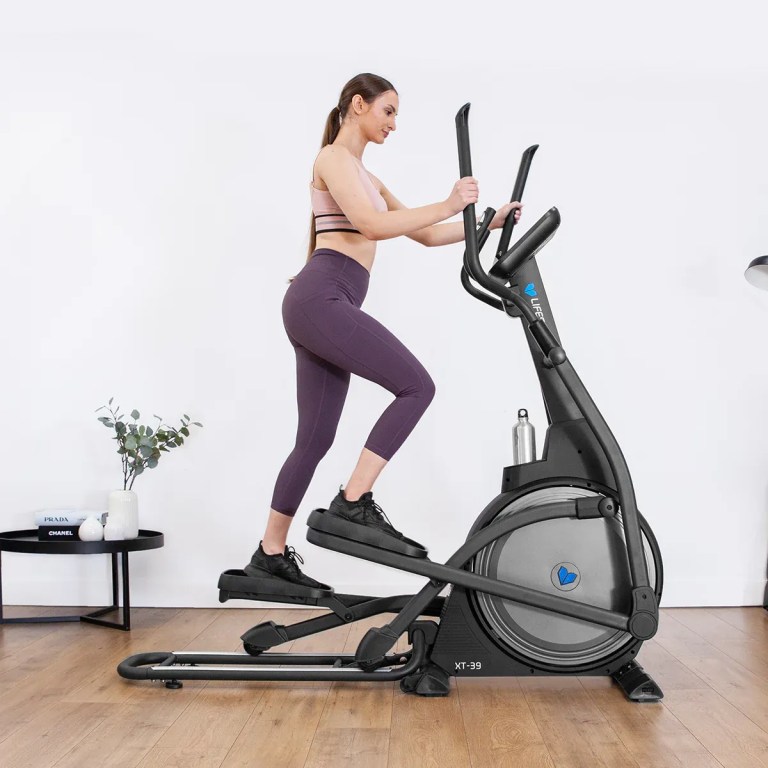 lifespan fitness xt 39 folding cross trainer Woman exercising on elliptical trainer at home