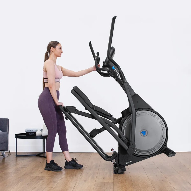 lifespan fitness xt 39 folding cross trainer Woman moving elliptical trainer in modern home