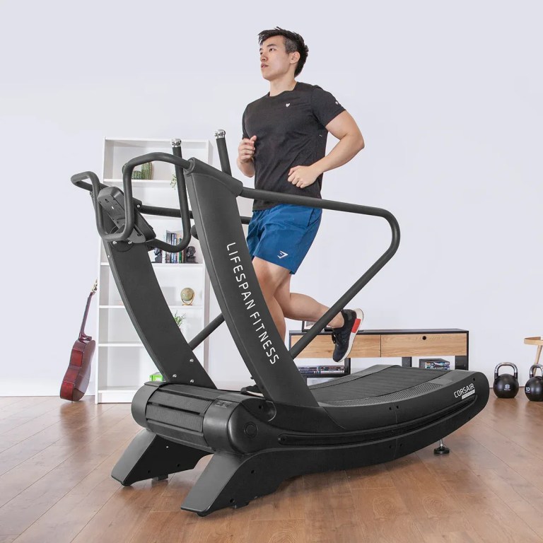 Man running on curved home treadmill