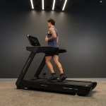 Man running on treadmill in modern gym