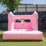Child jumping on pink inflatable castle outdoors