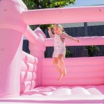 Child jumping in pink inflatable bouncy castle