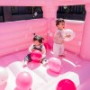 lifespan kids palace jumping castle pastel pink Two toddlers playing with balloons in pink castle