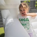 Smiling girl in sunny backyard wearing graphic tee