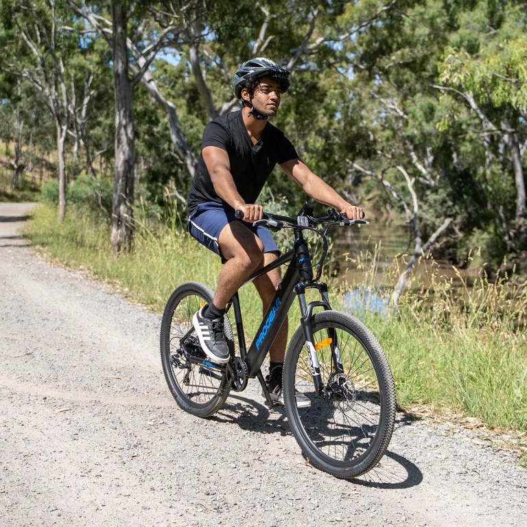 progear e vantage 27.5*18 mtb e bike black shadow" Man riding electric bike on bush trail