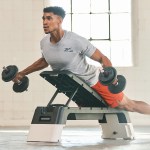 Man lifting dumbbells on incline bench