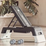 Reebok adjustable step bench with dumbbells indoors