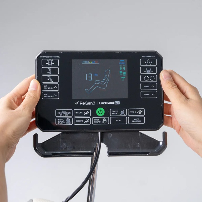regen8 luxcloud air zero gravity heated massage chair Hands holding massage chair remote control panel