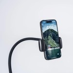Smartphone mounted on flexible stand against plain background