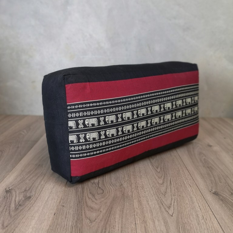 Rectangular elephant-patterned cushion on wooden floor