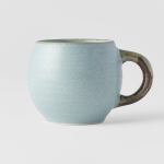 Light blue ceramic mug with brown handle