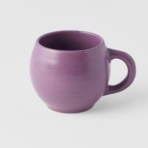 Purple ceramic mug on white background