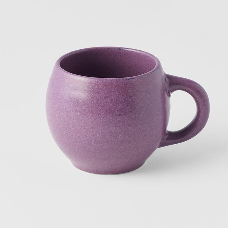 Purple ceramic mug on white background
