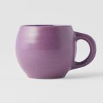 Purple ceramic coffee mug on white background