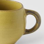 maru mug 300ml mustard glaze Close-up of yellow ceramic mug handle