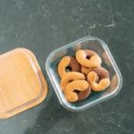 Glass container with mini bagels on countertop